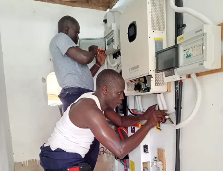 Engineer installing solar inverter