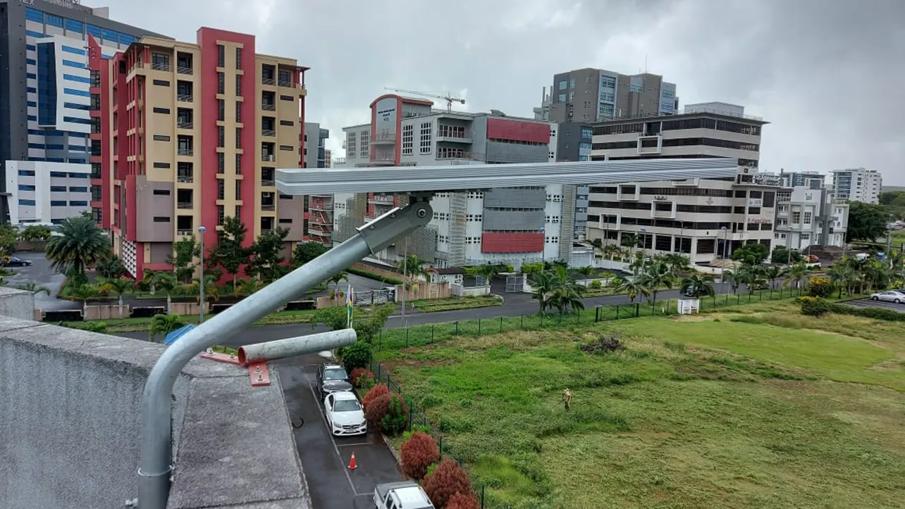 0911 50W solar LED street lights installed on a building rooftop, providing efficient and sustainable lighting for urban streets in Mauritius
